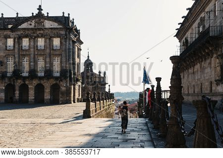 Unidentified Woman Is Walking Alone By Empty Obradoiro Square In Santiago