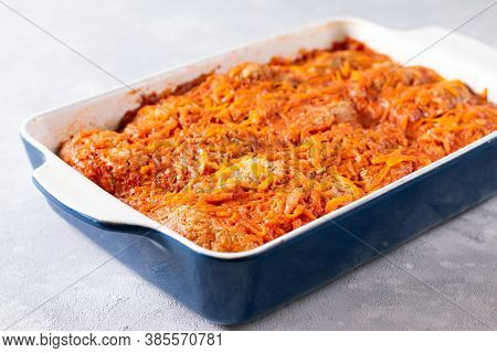 Baked Meatballs With Cabbage And Rice In A Baking Dish With Sour Sauce