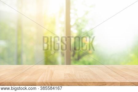 Wood Table Top (counter Bar) On Blur Of Window With Beautiful Garden In Morning Background.horizonta
