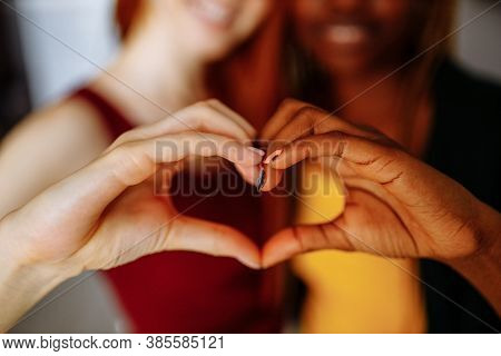 Cheerful Afro And European Lesbian Women At Home On The Bed