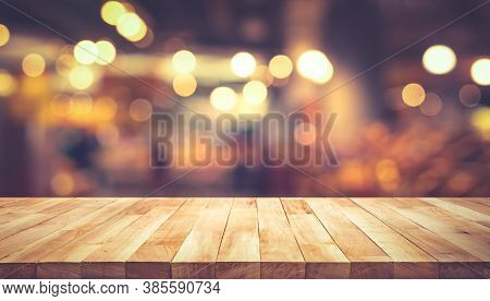 Wood Texture Table Top (counter Bar) With Blur Light Gold Bokeh In Cafe,restaurant Background.for Mo