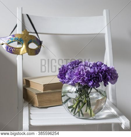 Bridal Bouquet Of Lilac Carnations In A Round Glass Vase As Decoration In White Interior