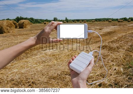 Mock Up Of A Smartphone And The Power Bank, In The Hand Of A Girl.