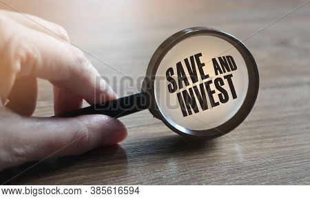 Save And Invest Under Magnifying Glass. Money Saving Trade And Investment Business Concept