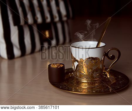 A Golden Coffee Cup And A Purse On The Table, Chocolate, Luxury Style Concept