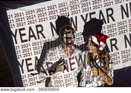 Beautiful Young Couple In Love Having Fun At New Years Eve Party, Singing And Dancing At Midninght C