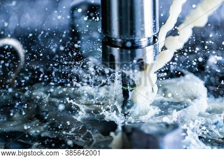 Close-up View Of Vertical Cnc Steel Milling Process With External Water Coolant Streams, Splashes An