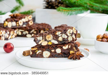 Panforte. Traditional Italian Christmas Dessert With Nuts And Dried Fruit On A White Background. Hor