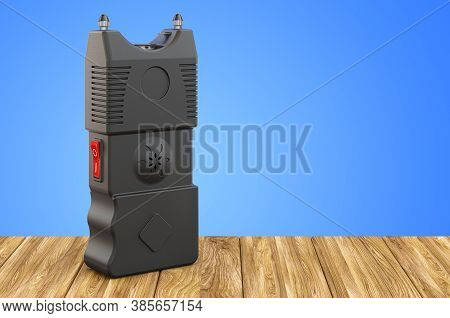 Stun Gun, Electroshock Weapon On The Wooden Table. 3d Rendering