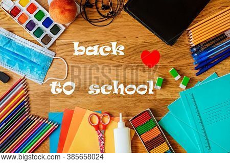 Top View Of School Stationery, Medical Mask. Back To School And Protection From Coronavirus. Text: B