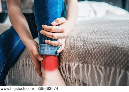 Young Girl Holds On To A Sore Leg. Close-up