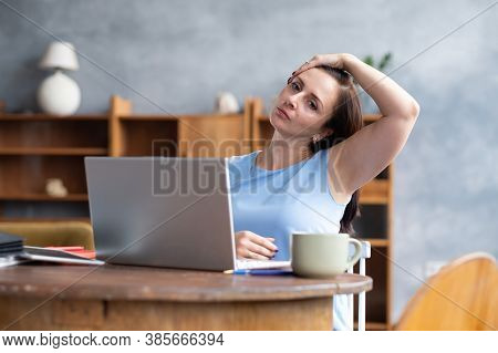 Young Caucasian Woman Stretching Side Of Neck Muscle During Work Break At Home