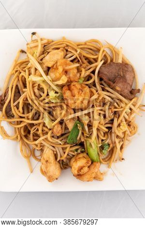 Appetizing Plate Tempting The Tastebuds With Pan Fried Soft Noodles In Perfect Serving Size.