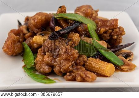 Detail View Of Appetizing Plate Tempting The Tastebuds With Tangerine Flavored Chicken In Perfect Se