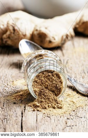 Ground Ginger In A Glass Jar And Fresh Ginger Root, Vintage Wooden Background, Selective Focus