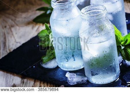 Cold Isotonic Solution For Sports Nutrition In Glass Bottles, Dark Background, Selective Focus