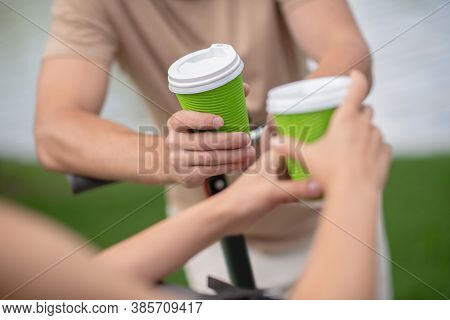 Close Up Picture Of Human Hands With Cups