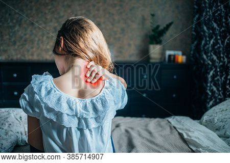 Young Girl Massages Back Pain. Selective Focus