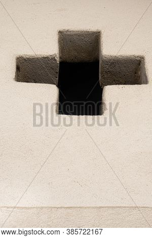 Mustair, Switzerland - September 8, 2020: A Window Sash In The Shape Of A Cross On The Facade Of An 