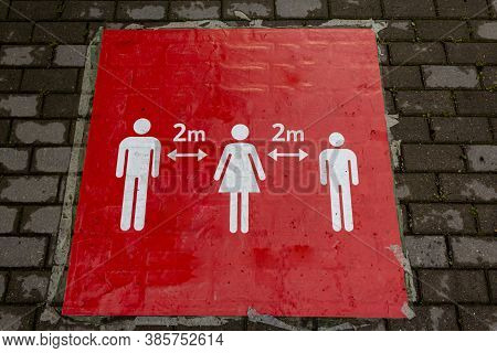 Red Sign On The Floor That Informs People To Keep A Social Distance. Sign Informing People To Keep 2