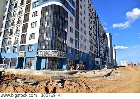 View On The Large Construction Site . Facde Of The Modern Multi-storey Residential Building. Use Of 