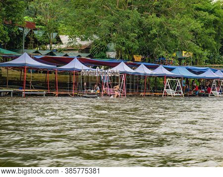 Vangvieng/lao-10 Dec 2017:unacquainted Tourist Sitting At Riverside Restaurant On Namsong River At V