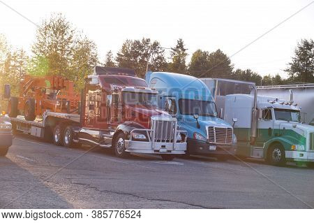 A Row Of Trucks. End Of The Day, The Setting Sun. Truck Stop.