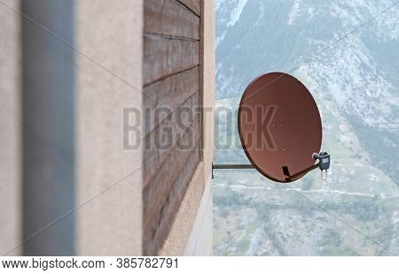 Tv Sattelite Dish Mounted On A Wooden House Wall, Rusted Dish