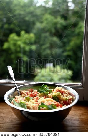 In Front Of A Window. Couscous With Mint, Tomato, Lemon And Olive Oil.