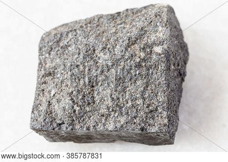 Closeup Of Sample Of Natural Mineral From Geological Collection - Unpolished Gabbro Rock On White Ma