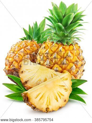 Pineapples with leaves and pineapple slices isolated on a white background. Clipping path.