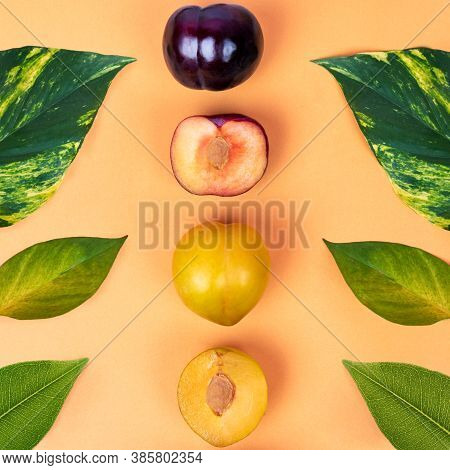 Colorful Plum Fruits On The Yellow Background Top View