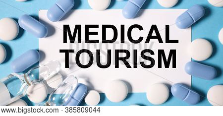 Medical Tourism, Text On A Blue Background, Next To Blue And White Tablets