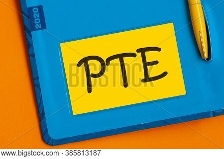 The Word Pte Is Written In Black Marker On The Yellow Paper For Notes. Pearson Tests Of English Pte 