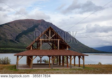 Outdoor Public Hall In Front Of A Lake With Mountains In The Background. Taken In Carcross, Yukon, C
