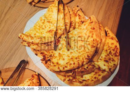 Georgian Cuisine Slised Megrelian Khachapuri Bread On The Wooden Table.