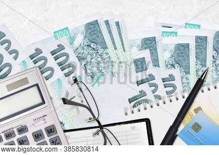 100 Czech Korun Bills And Calculator With Glasses And Pen. Tax Payment Concept Or Investment Solutio