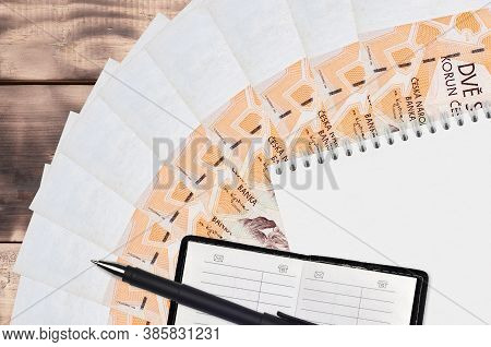 200 Czech Korun Bills Fan And Notepad With Contact Book And Black Pen. Concept Of Financial Planning