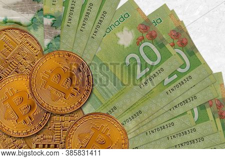 20 Canadian Dollars Bills And Golden Bitcoins. Cryptocurrency Investment Concept. Crypto Mining Or T