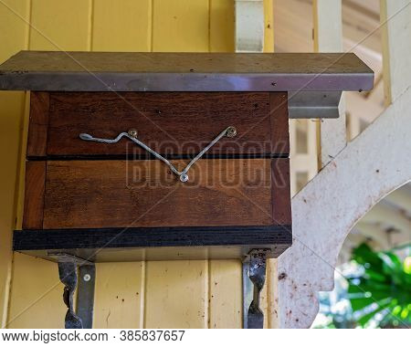 Timber And Metal Hive For Australian Bees Attached To The Wall Of An Old Country Cottage