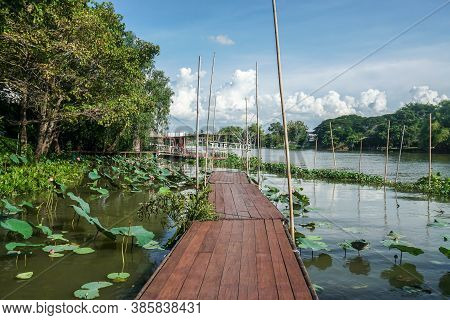 Nakornpathom / Thailand - September 5 2020: Wooden Walkway At Floating Raft Along The River At Tree 