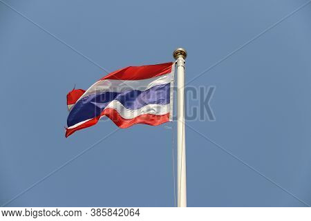National Flag Of Thailand On Bright Blue Sky Background. Blown Away By Wind. Thailand Is One Of The 
