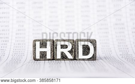 Three Stone Cubes On The Background Of White Financial Statements, Tables With The Word Hrd Human Re