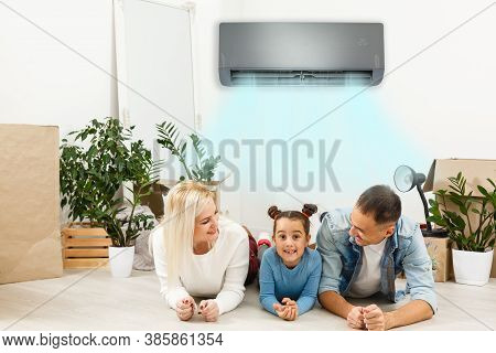 Happy Family Under Air Conditioning At Home