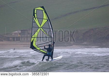 Windsurfer Riding Waves In Bigbury Bay, Devon