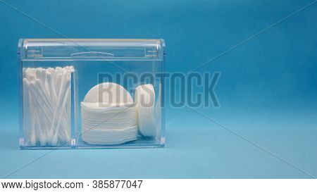 Organizer With White Cotton Pads And Cotton Swabs On A Blue Background With Copy Space