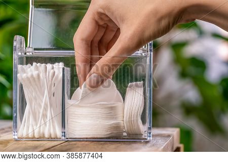 Woman's Hand Pulls Out A White Cotton Pad From The Organizer Close Up