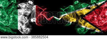 Italy Vs Guyana, Guyanese Smoky Mystic Flags Placed Side By Side. Thick Colored Silky Abstract Smoke