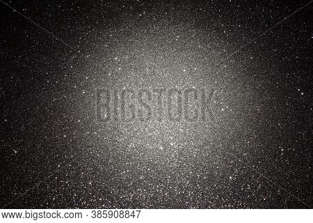 Black Texture With Micro-relief And Glitter. Black Glitter Texture With Illuminated Center