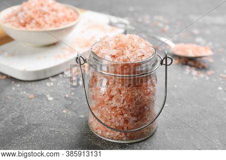 Pink Himalayan Salt In Glass Jar On Grey Table